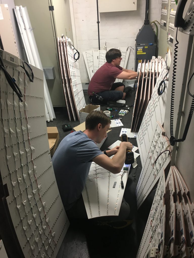 The two members of the Practically Perfect team wiring up some LED panels.
